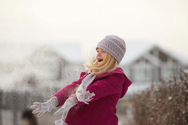 Child resident of Seton community in Calgary, Alberta playing in the snow