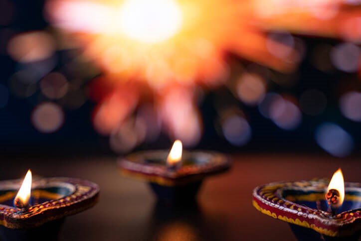 Seton community resident lighting candles to celebrate Diwali in Calgary, Alberta
